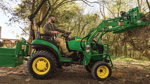 John Deere 2025R Compact Tractor Moving Branches
