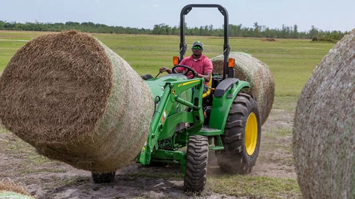John Deere 4044M Compact Tractor Moving Round Bales